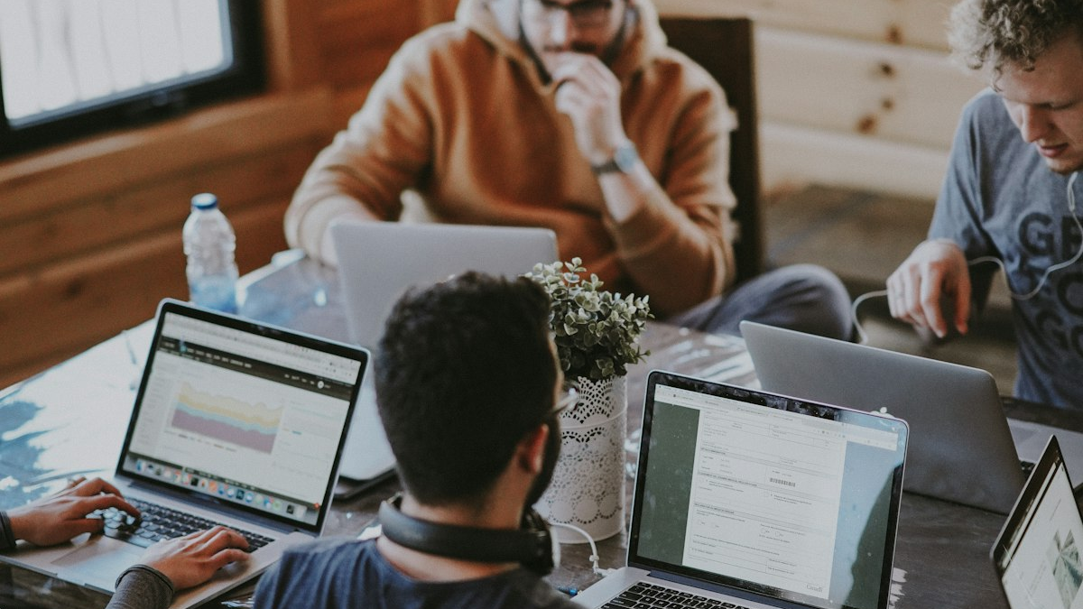 Предприниматель сидит за рабочим столом и смотрит в ноутбук с видимым напряжением и стрессом
